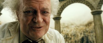 Movie still from “Filth” (2013), directed by Jon S. Baird – An old man with a white beard and a white shirt; Close Up shot, Low angle