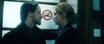 Movie still from “Filth” (2013), directed by Jon S. Baird – A man and a woman face each other in front of a no smoking sign; Close Up shot, Over the shoulder angle