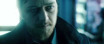 Movie still from “Filth” (2013), directed by Jon S. Baird – A person with a beard and blue eyes; Close Up shot, Over the shoulder angle