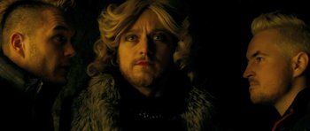 Movie still from “Filth” (2013), directed by Jon S. Baird – A person wearing a wig; Close Up shot, High angle
