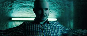 Movie still from “Filth” (2013), directed by Jon S. Baird – A man in a plaid shirt is looking at the camera; Close Up shot, High angle