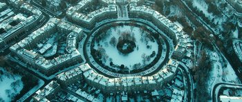 Movie still from “Filth” (2013), directed by Jon S. Baird – An aerial view of a city with snow on the ground; Extreme Wide shot, Overhead angle