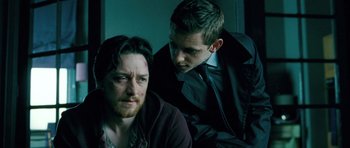 Movie still from “Filth” (2013), directed by Jon S. Baird – Two men are looking at each other in a dark room; Close Up shot, Over the shoulder angle