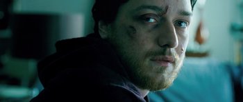 Movie still from “Filth” (2013), directed by Jon S. Baird – A person with a scar on his face; Close Up shot, Over the shoulder angle