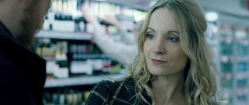 Movie still from “Filth” (2013), directed by Jon S. Baird – A beautiful blonde haired woman in a black and white jacket; Close Up shot, Over the shoulder angle