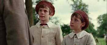 Movie still from “Finding Neverland” (2004), directed by Marc Forster – Two young boys wearing hats and jackets looking up; Close Up shot, Low angle