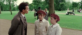 Movie still from “Finding Neverland” (2004), directed by Marc Forster – A group of young men standing next to each other on a field; Medium shot, Over the shoulder angle