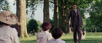 Movie still from “Finding Neverland” (2004), directed by Marc Forster – Two children sitting in the grass looking at trees; Wide shot, Low angle