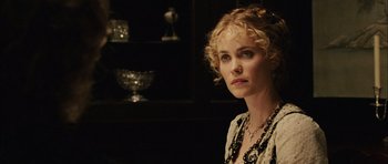 Movie still from “Finding Neverland” (2004), directed by Marc Forster – A woman with blonde curly hair wearing a black and white dress; Close Up shot, Over the shoulder angle