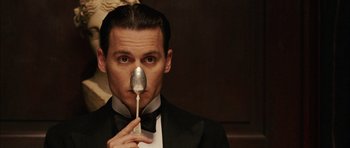 Movie still from “Finding Neverland” (2004), directed by Marc Forster – A man in a tuxedo holding a spoon up to his face; Close Up shot, Low angle