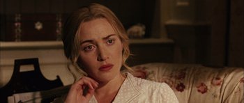 Movie still from “Finding Neverland” (2004), directed by Marc Forster – A person sitting on a couch with her hand under her chin; Close Up shot, Over the shoulder angle