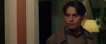 Movie still from “Finding Neverland” (2004), directed by Marc Forster – A man in a brown coat and a neck tie; Close Up shot, High angle