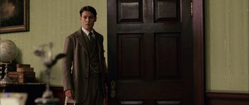 Movie still from “Finding Neverland” (2004), directed by Marc Forster – A man standing in front of an open door; Medium shot, Low angle