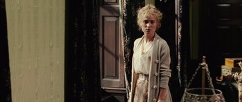 Movie still from “Finding Neverland” (2004), directed by Marc Forster – A woman standing in front of a window; Medium shot, Over the shoulder angle
