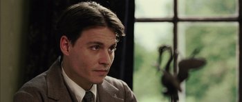 Movie still from “Finding Neverland” (2004), directed by Marc Forster – A person wearing a suit and tie; Close Up shot, Low angle