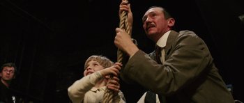 Movie still from “Finding Neverland” (2004), directed by Marc Forster – A man and a boy holding on to a rope; Medium shot, Low angle