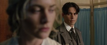 Movie still from “Finding Neverland” (2004), directed by Marc Forster – A man and a woman in a suit and tie looking at each other; Close Up shot, Over the shoulder angle