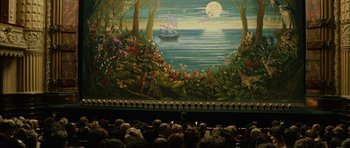 Movie still from “Finding Neverland” (2004), directed by Marc Forster – A painting of a boat in the ocean on the wall of a theater; Extreme Wide shot, High angle