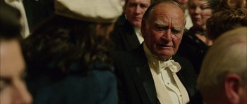 Movie still from “Finding Neverland” (2004), directed by Marc Forster – An older man in a tuxedo looking at a young woman; Close Up shot, Over the shoulder angle