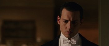 Movie still from “Finding Neverland” (2004), directed by Marc Forster – A person wearing a suit and bow tie; Close Up shot, Low angle