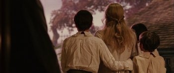 Movie still from “Finding Neverland” (2004), directed by Marc Forster – A couple of people standing next to each other; Medium shot, Over the shoulder angle