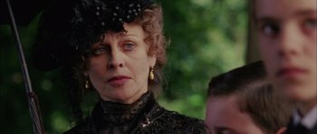 Movie still from “Finding Neverland” (2004), directed by Marc Forster – An older woman wearing a black dress and a black hat; Close Up shot, Over the shoulder angle