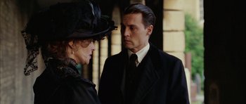 Movie still from “Finding Neverland” (2004), directed by Marc Forster – A man and a woman wearing suits and hats; Close Up shot, Over the shoulder angle