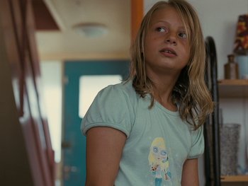 Movie still from “Fish Tank” (2009), directed by Andrea Arnold – A young girl standing in a room looking up at the ceiling; Close Up shot, Low angle