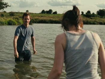 Movie still from “Fish Tank” (2009), directed by Andrea Arnold – A man and a woman wading in a body of water; Medium shot, Over the shoulder angle