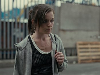 Movie still from “Fish Tank” (2009), directed by Andrea Arnold – A young woman is walking down the street; Close Up shot, Over the shoulder angle