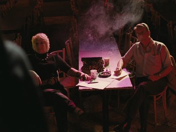 Movie still from “Fish Tank” (2009), directed by Andrea Arnold – A man and woman sitting at a dinner table; Wide shot, High angle
