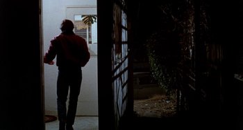 Movie still from “Five Easy Pieces” (1970), directed by Bob Rafelson – A person standing in front of an open door; Wide shot, Over the shoulder angle