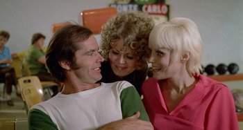Movie still from “Five Easy Pieces” (1970), directed by Bob Rafelson – Two women and a man smiling for the camera; Close Up shot, Over the shoulder angle