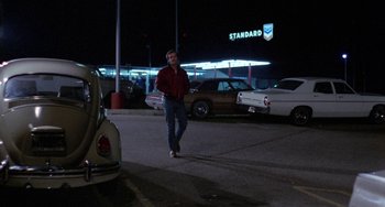 Movie still from “Five Easy Pieces” (1970), directed by Bob Rafelson – A man walking in a parking lot at night; Wide shot, Over the shoulder angle