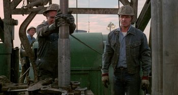 Movie still from “Five Easy Pieces” (1970), directed by Bob Rafelson – Two men working on a drilling rig in an oil field; Medium shot, Low angle