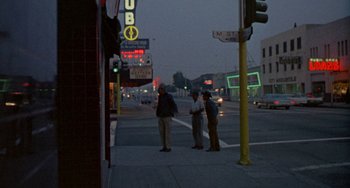 Movie still from “Five Easy Pieces” (1970), directed by Bob Rafelson – Three men standing on the side of the road at night; Wide shot, Low angle