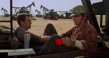 Movie still from “Five Easy Pieces” (1970), directed by Bob Rafelson – Two men sitting in the back of a pick - up truck; Medium shot, Over the shoulder angle