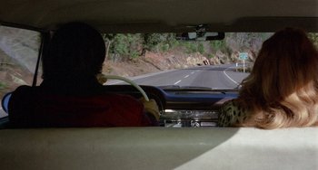 Movie still from “Five Easy Pieces” (1970), directed by Bob Rafelson – A woman driving a car on the side of a road; Wide shot, High angle