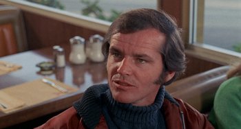 Movie still from “Five Easy Pieces” (1970), directed by Bob Rafelson – A person sitting at a table; Close Up shot, Over the shoulder angle