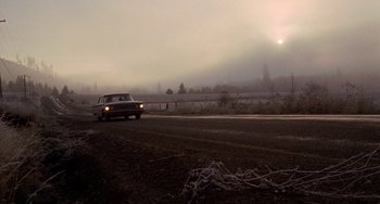 Movie still from “Five Easy Pieces” (1970), directed by Bob Rafelson – A car driving down a road on a foggy day; Extreme Wide shot, Low angle