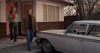 Movie still from “Five Easy Pieces” (1970), directed by Bob Rafelson – A man walking down the sidewalk next to a car; Wide shot, Low angle
