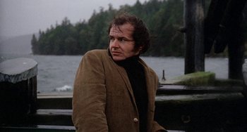 Movie still from “Five Easy Pieces” (1970), directed by Bob Rafelson – A man in a brown jacket standing next to a body of water; Close Up shot, Low angle