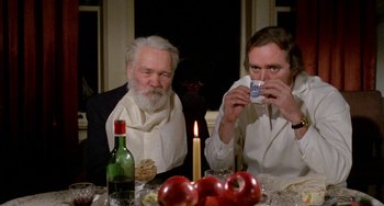 Movie still from “Five Easy Pieces” (1970), directed by Bob Rafelson – Two men sitting at a dinner table with a candle; Medium shot, High angle