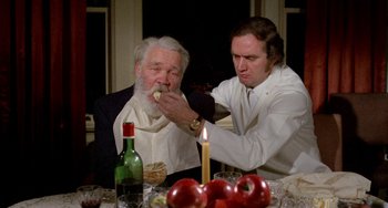 Movie still from “Five Easy Pieces” (1970), directed by Bob Rafelson – A man feeding a man a piece of food; Medium shot, High angle