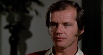Movie still from “Five Easy Pieces” (1970), directed by Bob Rafelson – A person wearing a shirt and tie; Close Up shot, Over the shoulder angle