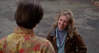 Movie still from “Five Easy Pieces” (1970), directed by Bob Rafelson – A woman smiles at another woman while standing outside; Medium shot, Over the shoulder angle