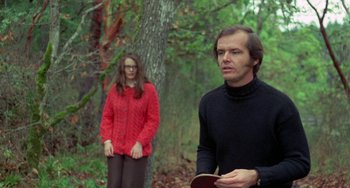 Movie still from “Five Easy Pieces” (1970), directed by Bob Rafelson – A man and a woman standing next to each other in the woods; Medium shot, Over the shoulder angle