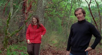 Movie still from “Five Easy Pieces” (1970), directed by Bob Rafelson – A man and a woman walking through the woods; Medium shot, High angle