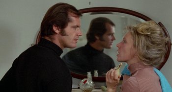 Movie still from “Five Easy Pieces” (1970), directed by Bob Rafelson – A man and a woman looking at each other in front of a mirror; Close Up shot, Over the shoulder angle