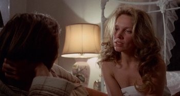 Movie still from “Five Easy Pieces” (1970), directed by Bob Rafelson – A man and a woman sitting in front of each other in front of a lamp; Close Up shot, Over the shoulder angle